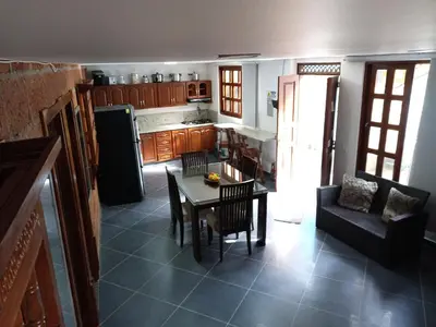 a kitchen and dining room with a table and chairs at Casa Finca Hotel Loma Encantada in Guatapé