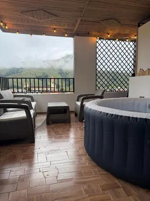 a large room with couches and a large window at edificiourrao in Urrao