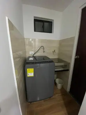 a small bathroom with a sink and a television on the wall at edificiourrao in Urrao