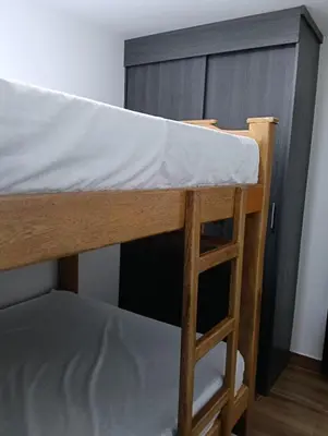 a bunk bed with a ladder next to a cabinet at edificiourrao in Urrao