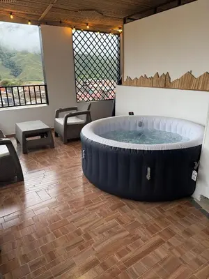 a large hot tub in a room with tables and chairs at edificiourrao in Urrao
