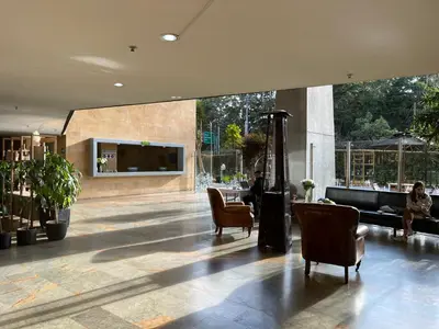 a lobby with chairs and a fireplace in a building at Nmadas digitales - Hotel Rioverde in San Antonio de Pereira