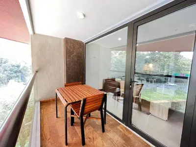 a room with a wooden table and a large window at Nmadas digitales - Hotel Rioverde in San Antonio de Pereira