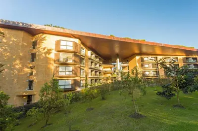 an apartment building with a garden in front of it at Nmadas digitales - Hotel Rioverde in San Antonio de Pereira
