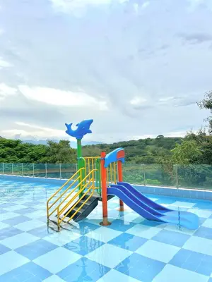 a water park with a slide in a swimming pool at Apartamento Vacacional San Jerónimo in Medellín