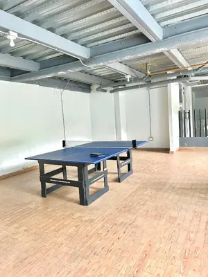 a blue ping pong table in an empty room at Apartamento Vacacional San Jerónimo in Medellín