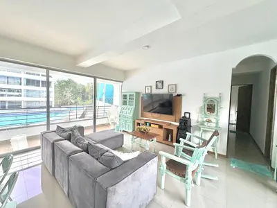 a living room with a couch and a television at Apartamento Vacacional San Jerónimo in Medellín