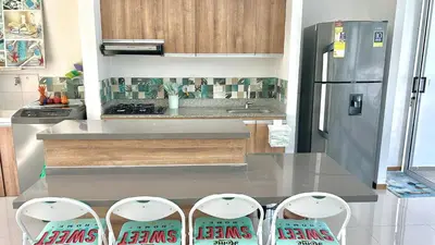 a kitchen with a table and two chairs and a refrigerator at Apartamento Vacacional San Jerónimo in Medellín
