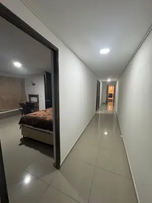 a bedroom with a bed and a large mirror at Amplio apartamento en la 70 Estadio Laureles para grupos familiares o amigos in Medellín