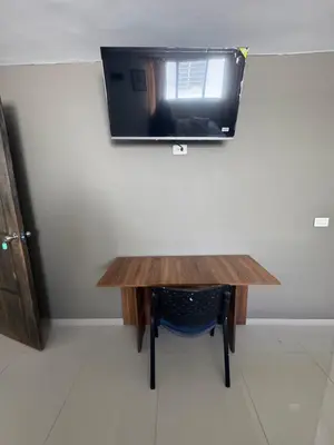 a wooden table with a mirror on a wall at Amplio apartamento en la 70 Estadio Laureles para grupos familiares o amigos in Medellín