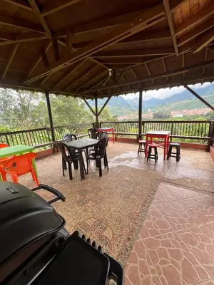 a group of tables and chairs on a patio at Hostal Artesanos in Jardin