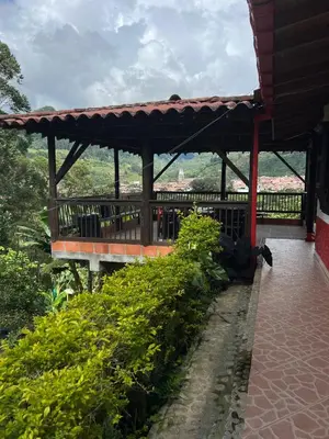 a wooden pavilion with a view of the mountains at Hostal Artesanos in Jardin