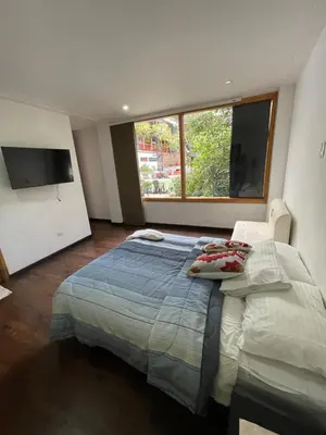 a bedroom with a large bed and a large window at ATHOS hotel boutique B&B in Pensilvania