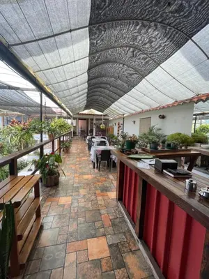 a restaurant with a patio with tables and a ceiling at ATHOS hotel boutique B&B in Pensilvania
