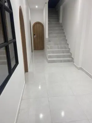 a hallway with stairs and a wooden door at Habitaciones en Doradal 203 in Doradal