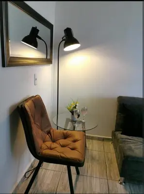 a room with a table and a chair and a lamp at Espectacular vista panorámica de norte a sur in Bello
