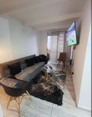 a living room with a couch and a flat screen tv at Espectacular vista panorámica de norte a sur in Bello