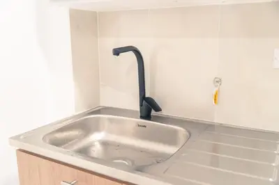 a kitchen sink with a faucet on top of it at Aparta estudio 202 - Casa Bendita in Medellín