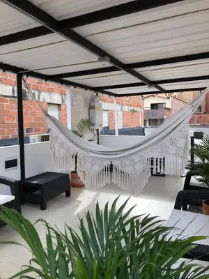 a hammock on the patio of a building at Aparta estudio 202 - Casa Bendita in Medellín
