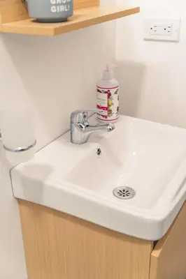 a bathroom sink with a bottle of soap on it at Aparta estudio 202 - Casa Bendita in Medellín