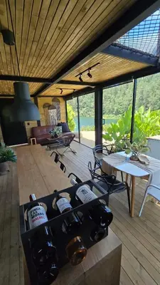 a room with chairs and a table with wine bottles at Villa Deluxe Curazao in El Peñol