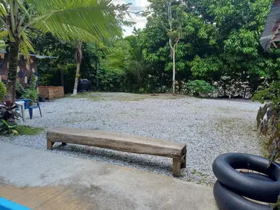 a wooden bench sitting in a yard with a playground at Finca LA CASCADA in Mesa del Norte