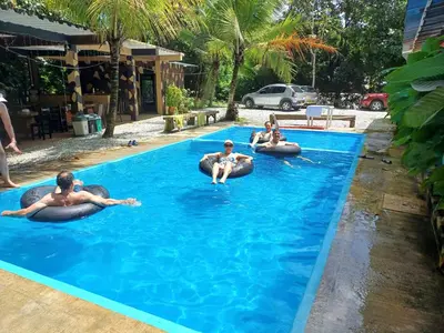 a group of people laying on inflatables in a swimming pool at Finca LA CASCADA in Mesa del Norte