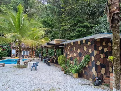 a resort with a building and a swimming pool at Finca LA CASCADA in Mesa del Norte