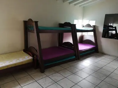 a room with two bunk beds in a room at Finca Villa Cristian Copacabana Antioquia in Copacabana