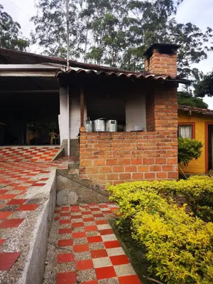 a brick house with pots in a window at Finca Villa Cristian Copacabana Antioquia in Copacabana