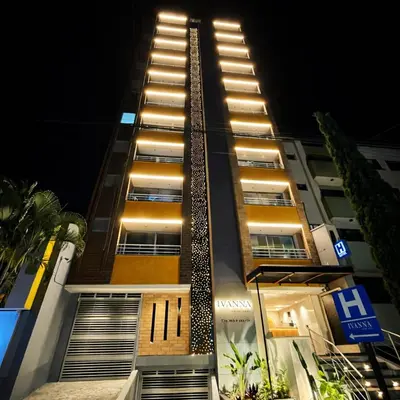 a tall building with stairs on the side at night at Ivanna Jumar ApartaHotel - Laureles Estadio in Medellín