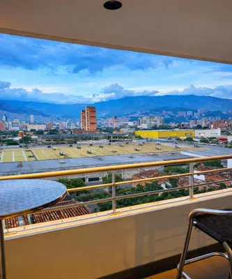 a view of a city from a balcony at Ivanna Jumar ApartaHotel - Laureles Estadio in Medellín