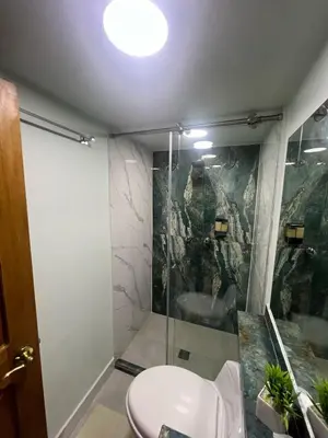 a bathroom with a shower with a toilet and a sink at Casa Boutique La Corona Medellin in Envigado