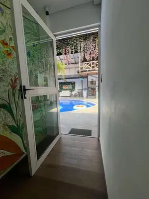 an open door with a view of a swimming pool at Casa Boutique La Corona Medellin in Envigado