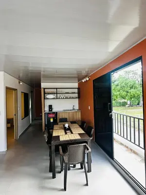a dining room with a table and chairs and a balcony at CASA JAZZ Armonía y relax in Mariquita