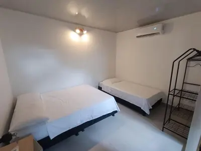 a small room with two beds and a shelf at CASA JAZZ Armonía y relax in Mariquita