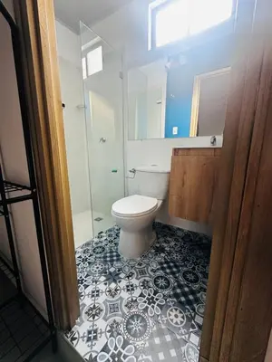 a bathroom with a toilet and a glass shower at CASA JAZZ Armonía y relax in Mariquita