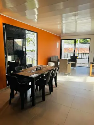 a dining room with a wooden table and chairs at CASA JAZZ Armonía y relax in Mariquita