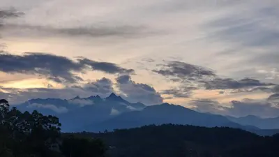 a cloudy sky with mountains in the background at Finca Carrizales in Jardin