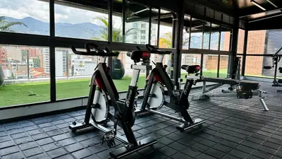 two bikes are parked in a room with windows at Ubicación Privilegiada Laureles Medellin con Vista y AC in Medellín
