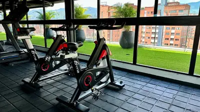 two bikes parked in a gym next to a window at Ubicación Privilegiada Laureles Medellin con Vista y AC in Medellín