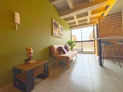 a living room with a couch and a table at c202 - Loft, hab1, baño 1, 1tv, sofacama, wifi in La Ceja
