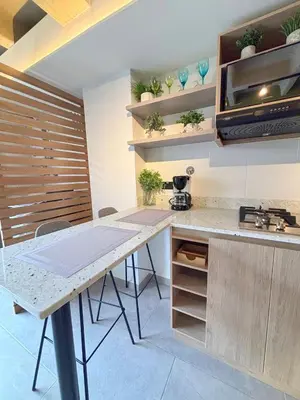 a kitchen with a table and some plants on shelves at c202 - Loft, hab1, baño 1, 1tv, sofacama, wifi in La Ceja