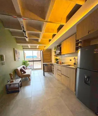 a kitchen with a refrigerator and a living room at c202 - Loft, hab1, baño 1, 1tv, sofacama, wifi in La Ceja
