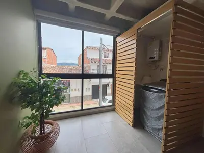 a room with a large window and a potted plant at c202 - Loft, hab1, baño 1, 1tv, sofacama, wifi in La Ceja