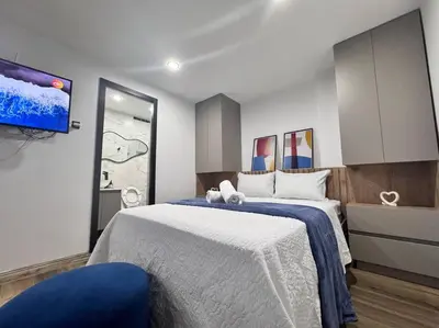 a bedroom with a large bed with a blue blanket at 1905 Apto con estilo & moderno poblado in Medellín