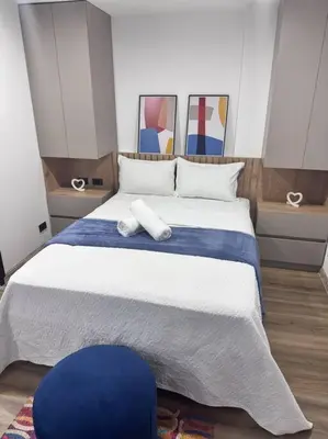 a bedroom with a large bed with a blue and white blanket at 1905 Apto con estilo & moderno poblado in Medellín