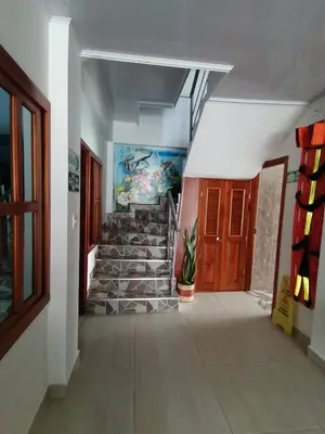 a hallway with stairs and a painting on the wall at Hotel Glorial in Doradal