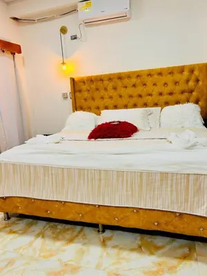 a large bed with a red flower on it at Hotel Glorial in Doradal