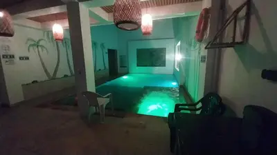 a room with a swimming pool in a house at Hotel Glorial in Doradal